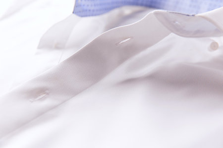 Close up of a white shirt with a blue and white collar.の写真素材
