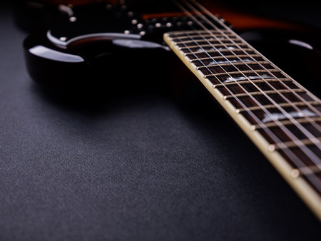 Guitar on black background, close up view. Musical instrument