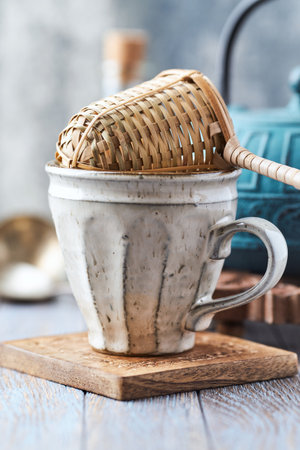Coffee cup and teapot on a wooden table.