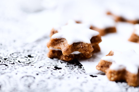 Christmas cookies with icing sugar on a black background. Selective focus.