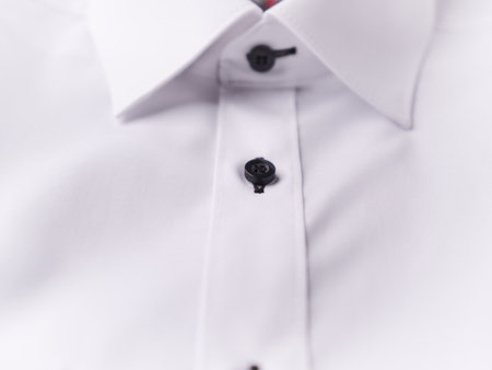 Close up of white shirt with black buttons, isolated on white background