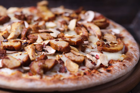 Pizza with mushrooms and apples on a wooden background. Close upの写真素材