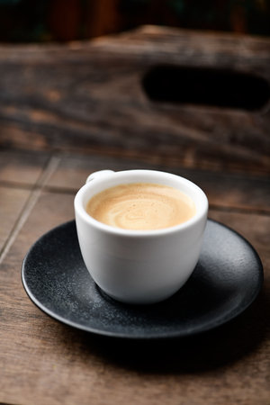 Coffee cup on wooden table in coffee shop, stock photoの写真素材