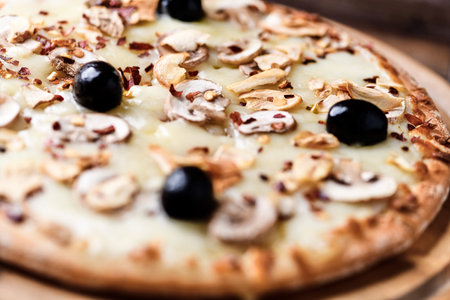 pizza with mushrooms and olives on a wooden background. tinting. selective focusの写真素材