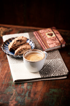 Cup of coffee with cookies on old wooden table, selective focusの写真素材