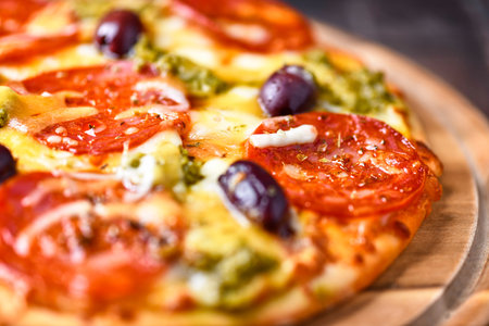 Pizza with mozzarella cheese, tomatoes and olives.の写真素材