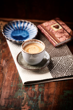 Coffee cup and book on a wooden background. Selective focus.の写真素材