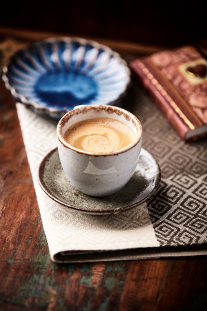 Coffee cup and book on old wooden table, selective focusの写真素材