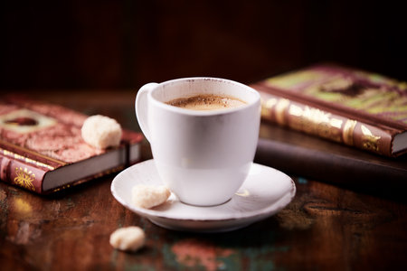 Coffee cup and books on a wooden table. Selective focus.の写真素材