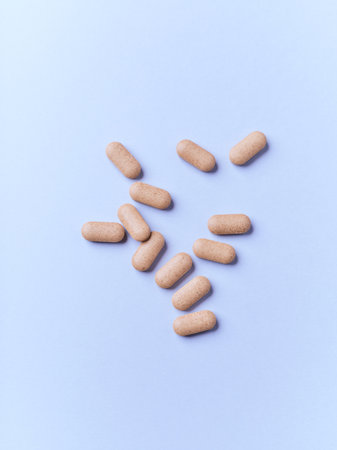 Pills on a blue background. Top view. Copy space.
