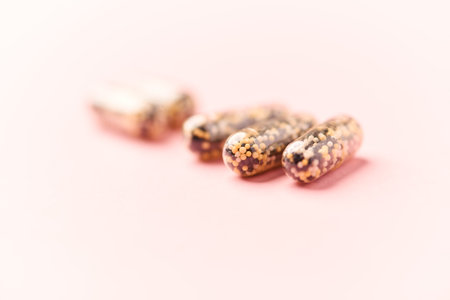 Iron capsules on bright background. Soft focus. Close up. Copy space.