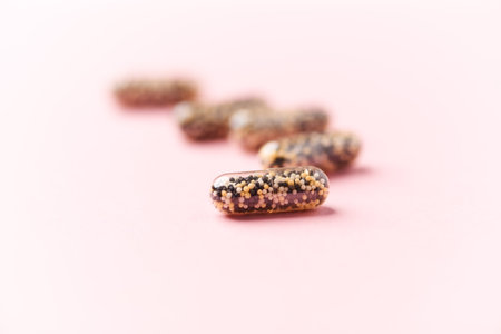 Pills on a pink background. Concept of dietary supplements and healthy lifestyle.