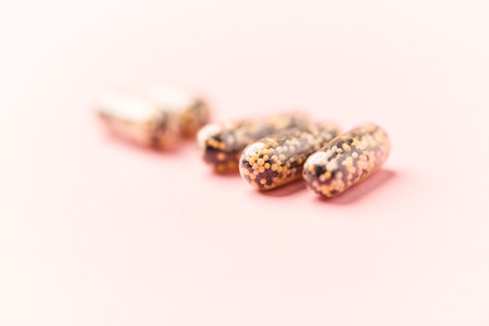 Dried quinoa seeds on pink background. Healthy food concept.