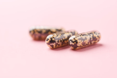 Capsules of omega 3 on a pink background close-up