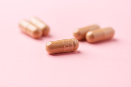 Capsules of medicine on a pink background. Copyspace.の写真素材