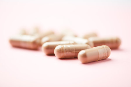 Pills on a pink background. Focus on foreground, soft bokeh.の写真素材