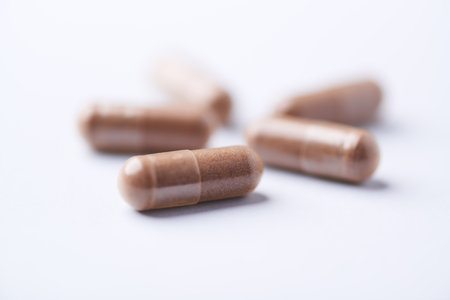 Close-up of pills on white background. Focus on foreground.の写真素材