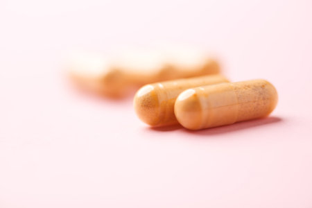 Close up of pills on pink background. Focus on foreground, soft bokeh.の写真素材