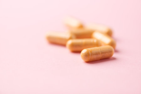 Pills on pink background, closeup. Concept of healthy lifestyleの写真素材