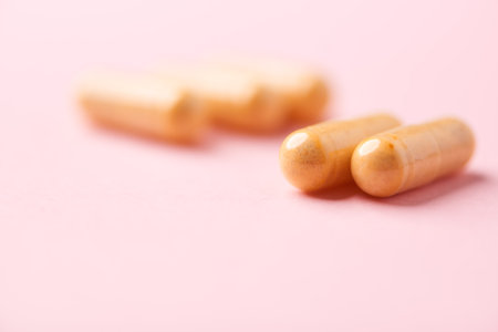 Close up of pills on pink background. Focus on foreground, shallow depth of field.の写真素材