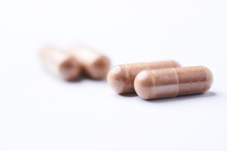 Close up of pills on white background. Focus on foreground, soft bokeh.