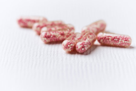 Close up of pink pills on white background. Focus on foreground.の写真素材