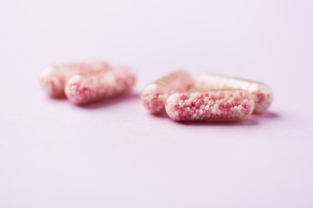 Pills on a pink background. Close up. Selective focus.