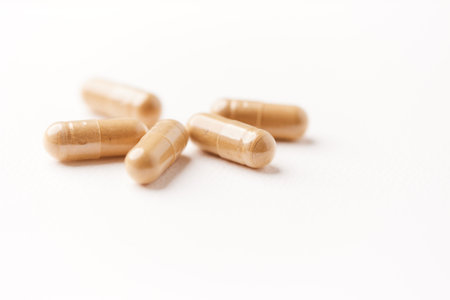 Capsules on white background. Focus on foreground, soft bokeh.