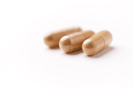 Close up of capsules on white background. Focus on foreground, soft bokeh.