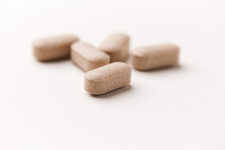 Pills on white background. Focus on foreground, soft bokeh.の写真素材