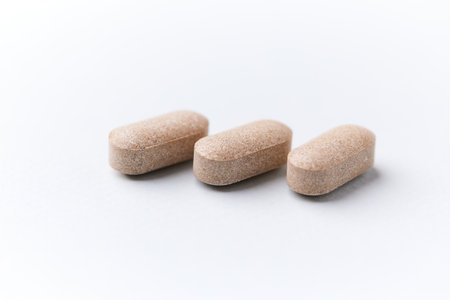 Pills on a white background. Focus on foreground, shallow DOF.