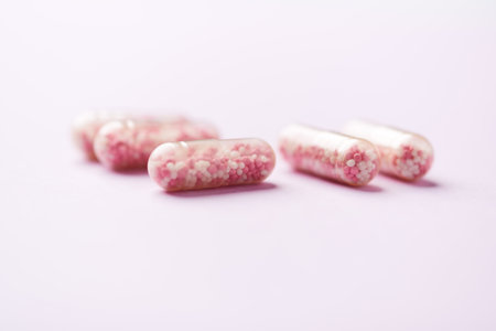 Pink pills on a pink background. Focus on foreground, soft bokeh.の写真素材
