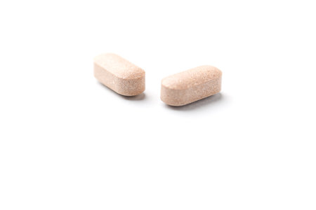 Pills isolated on white background. Focus on foreground, soft bokeh.