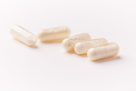 Close up of white pills on white background. Focus on foreground.の写真素材