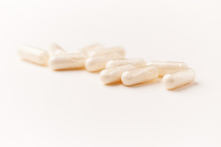 Close up of a group of white pills on a white background.の写真素材