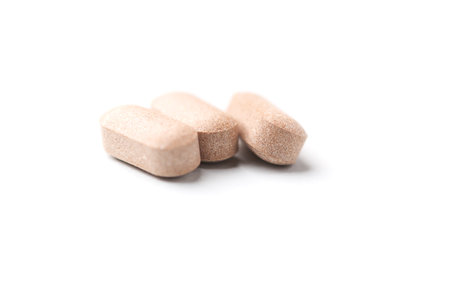 Pills isolated on white background. Focus on foreground, soft bokeh.