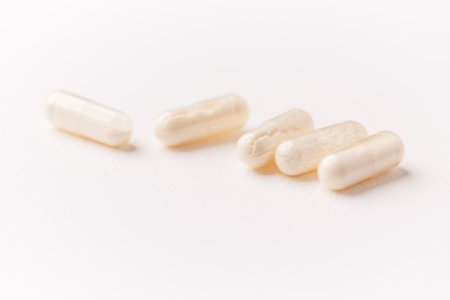 Close-up of capsules on white background. Focus on foreground.