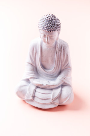 Buddha statue isolated on pink background, closeup of photoの写真素材