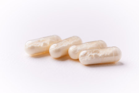 Close-up of pills on white background. Focus on foreground, soft bokeh.の写真素材