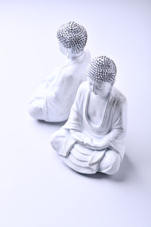 Buddha statue on a white background, closeup of photoの写真素材
