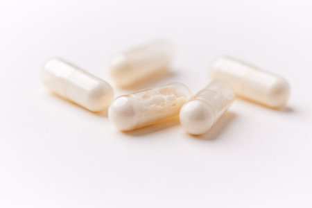 Capsules of white pills on a white background close-up