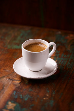 Coffee cup on old wooden table, vintage style, selective focusの写真素材