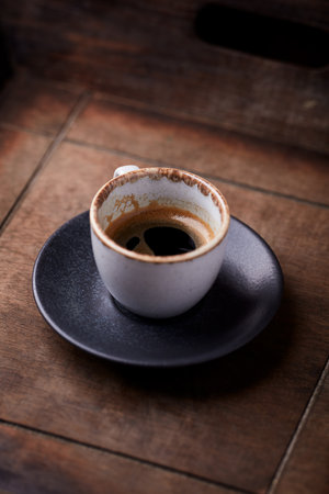 Coffee cup on old wooden table in coffee shop, stock photoの写真素材