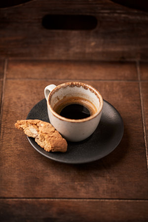 Cup of coffee with cookies on a wooden background. Toned.の写真素材