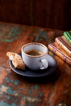 Cup of coffee and cookies on old wooden table, stock photoの写真素材