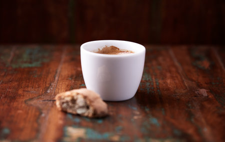 Coffee cup and cookies on a wooden background. Close up.