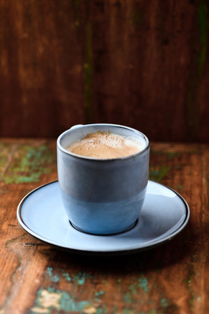 Coffee cup on old wooden table, vintage style, selective focusの写真素材