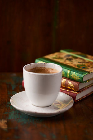 Cup of coffee and books on old wooden table, selective focusの写真素材