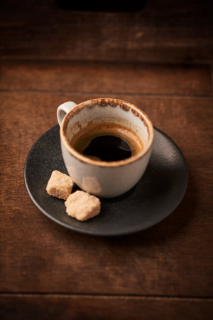 Coffee cup with sugar cubes on wooden table, stock photoの写真素材