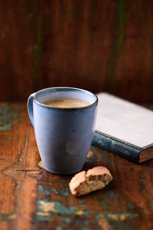 Cup of coffee and cookies on old wooden table, selective focusの写真素材